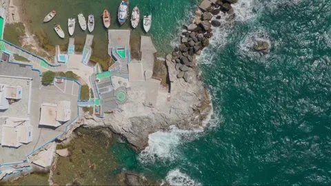 Aerial drone view of harbor and boat on turquoise sea coast Stock Footage 341823153
