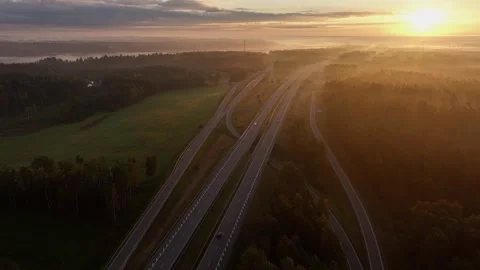 Aerial Drone View of Highway Interchange at Golden Sunrise in Misty Countryside 스톡 동영상 344598141