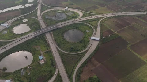 Aerial drone view of highway interchange and curved road network surrounded Stock Footage 345464511