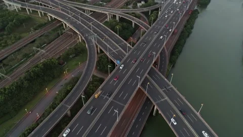Aerial drone view of highway multi-level junction road with moving car at sunset Stock Footage 144923967