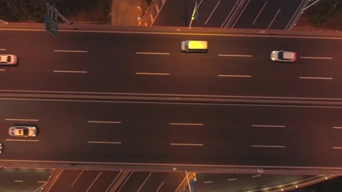 Aerial drone view of highway multi-level junction road with moving car at night Video stock 146001752