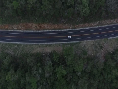 Aerial drone view of highway through mountains Stock Footage 78374116