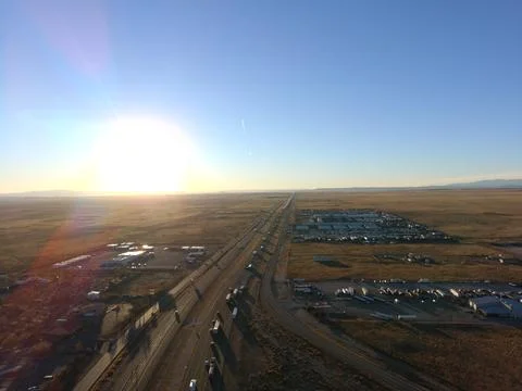 Aerial Drone View of Interstate Highway Through Desert Landscape at Sunset Stock Photos