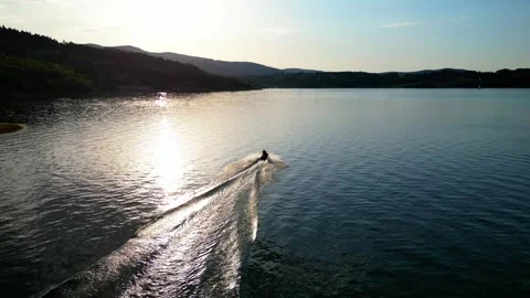 Aerial Drone View of Jet Ski on Mountain Lake at Sunset Stock Footage 346181425