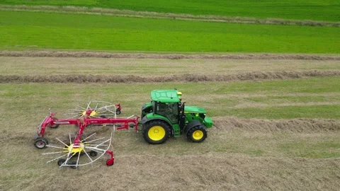 Aerial Drone view of John Deere tractor from side working in a field Stock Footage 276963038