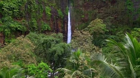 Aerial drone view of Kapas Biru waterfall in lush tropical jungle in Indonesia Stock-Footage 336561123