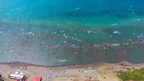 Aerial drone view of kiteboarder pulled across sea by power - Water and Surfing Stock Footage 340608580