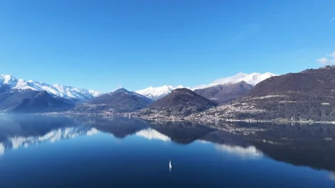 Aerial drone view of Lake Como mountains reflected on calm water Video stock 328010038