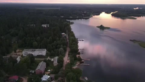 Aerial drone view of Lake Seliger shoreline with buildings at sunset Stock Footage 338095997