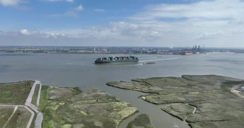 Aerial drone view of a large container ship leaving the port of Antwerpen and 스톡 동영상 256686576