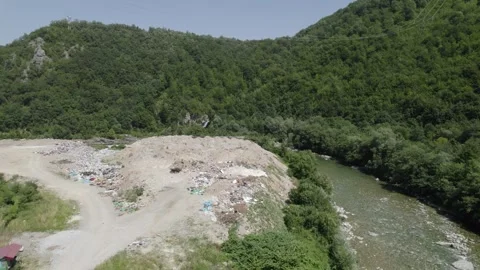 Aerial drone view of large garbage landfill close to clean mountain river. Stock Footage 261045104