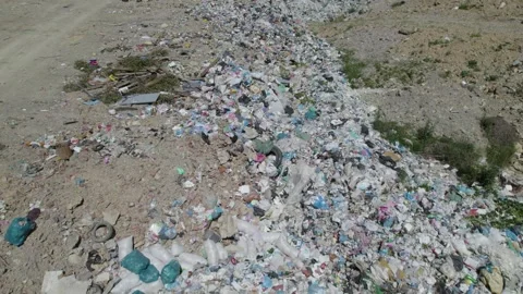 Aerial drone view of large garbage landfill close to clean mountain river. Stock Footage 261045138