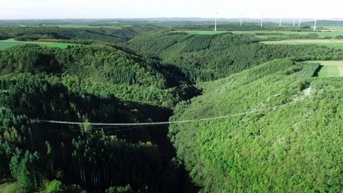 Aerial Drone View of a large hanging suspension bridge in green summer 스톡 동영상 122373867