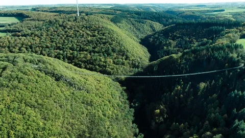 Aerial Drone View of a large hanging suspension bridge in green summer 스톡 동영상 122375520