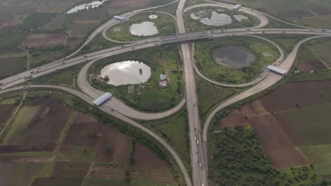 Aerial drone view of large highway interchange with circular road ramps Stock Footage 345462832