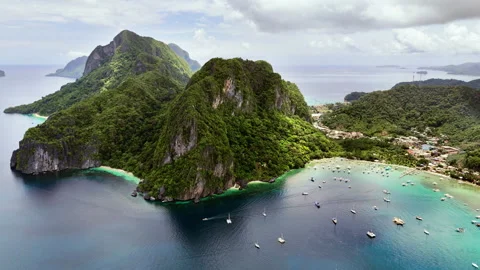 Aerial drone view of a large limestone karst headland and El Nido town Видео 336677100