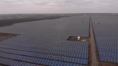 Aerial drone view into large solar panels at a solar farm at cloudy autumn day Stock Footage 124860429