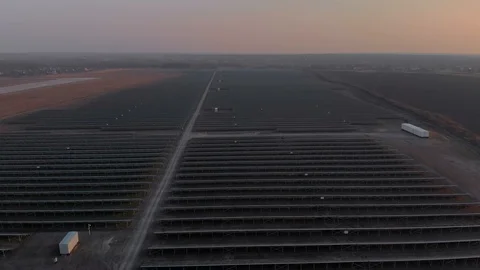 Aerial drone view into large solar panels at a solar farm. Solar cell power Stock Footage 127437907