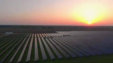 Aerial drone view into large solar panels at a solar farm at summer sunset Stock Footage 132131860