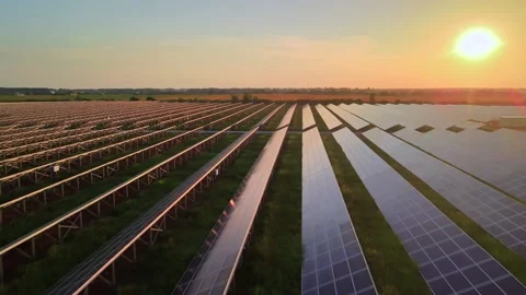Aerial drone view into large solar panels at a solar farm at bright sunset Stock Footage 161180179