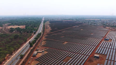 Aerial Drone View of Large Solar Farm Beside Highway in India Stock Footage 334960246
