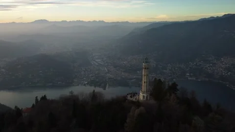 Aerial drone view of a lighthouse over Lake Como skyline with sunset light Stock Footage 169405787