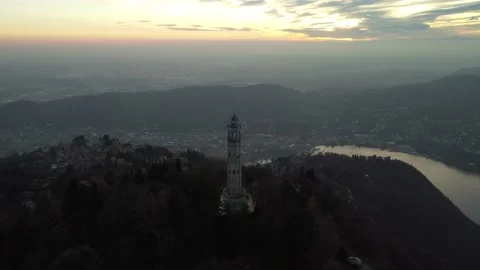 Aerial drone view of a lighthouse over Lake Como skyline with sunset light Stock Footage 170665672