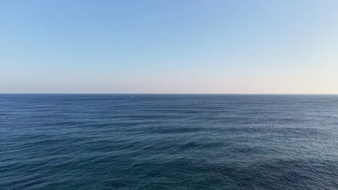 Aerial Drone View of Lighthouse Surrounded by Shimmering Sea Stock Footage 344778144