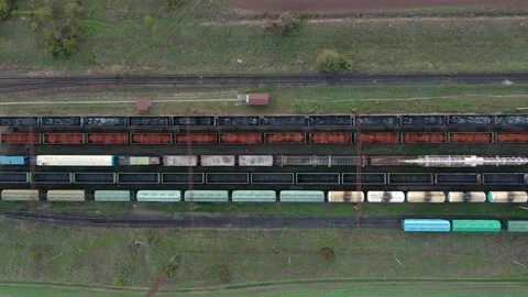 An aerial drone view of a locomotive pulling railway carriages Stock Footage 145648064