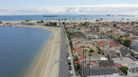 Aerial drone view of Long Beach street overlooking Marine Stadium and Ocean Stock Footage 128996904