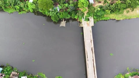 Aerial drone view of a long concrete bridge crossing over a wide river Stock Footage 341519994