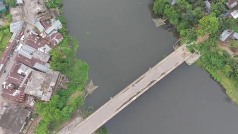 Aerial drone view of a long concrete bridge crossing over a wide river Stock Footage 341520066