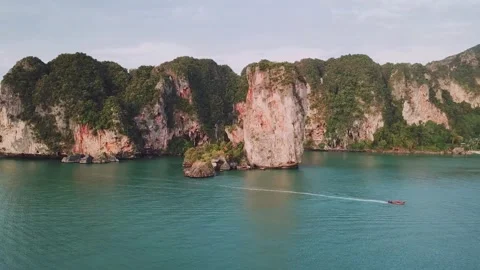 Aerial drone view of longtail boat cruising in Krabi, Thailand 動画素材 345592571