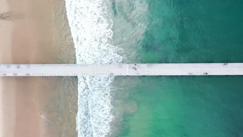 Aerial drone view looking down on Hermosa Beach Pier as Waves Break Stock Footage 321778126