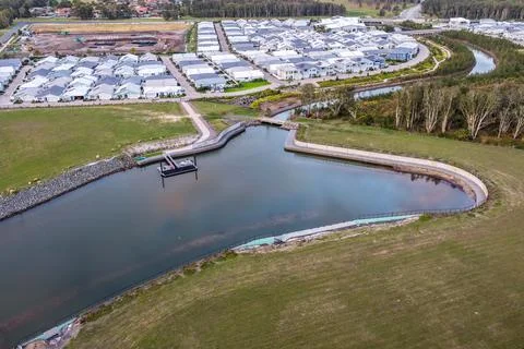 Aerial drone view looking down over a jetty extending into a calm water inl.. Фото