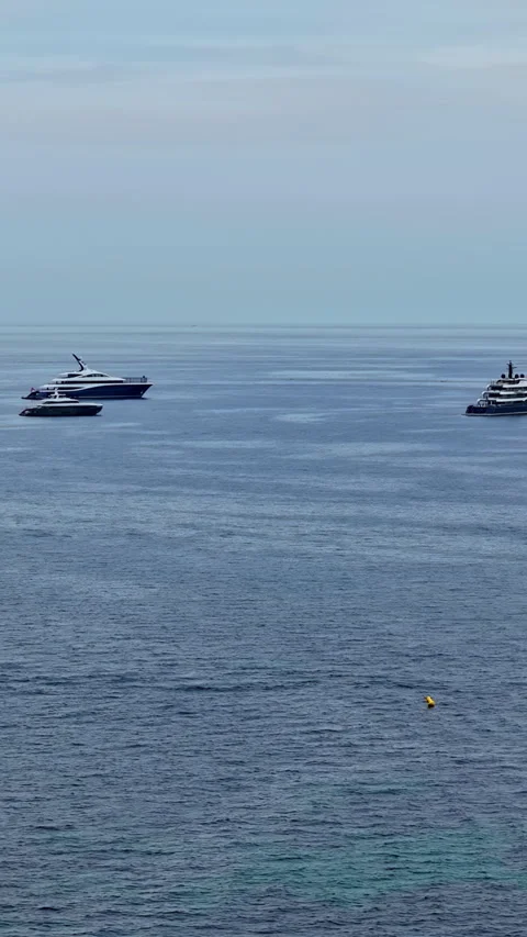 Aerial drone view of luxury superyachts anchored in the calm waters off Cannes Stock Footage 318811253