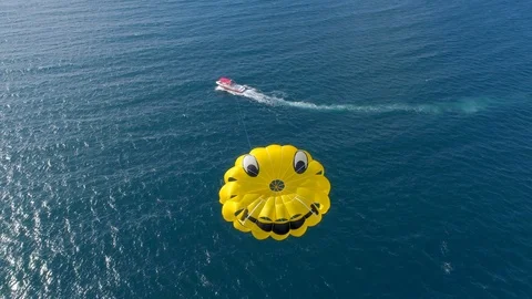 Aerial drone view of a man and woman couple parasailing tandem over a tropical i Stock Footage 110056750
