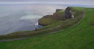 Aerial Drone View Of Man Walking On Cliff Edge At Cliffs Of Moher Stock Footage