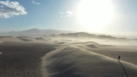 Aerial Drone View of a man walking across the top of a Sand Dune Video stock 326721075