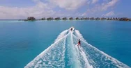 Aerial Drone View Of A Man Water Skiing Near A Tropical Island. Stock Footage