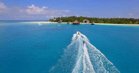 Aerial drone view of a man water skiing near a tropical island. Stock Footage