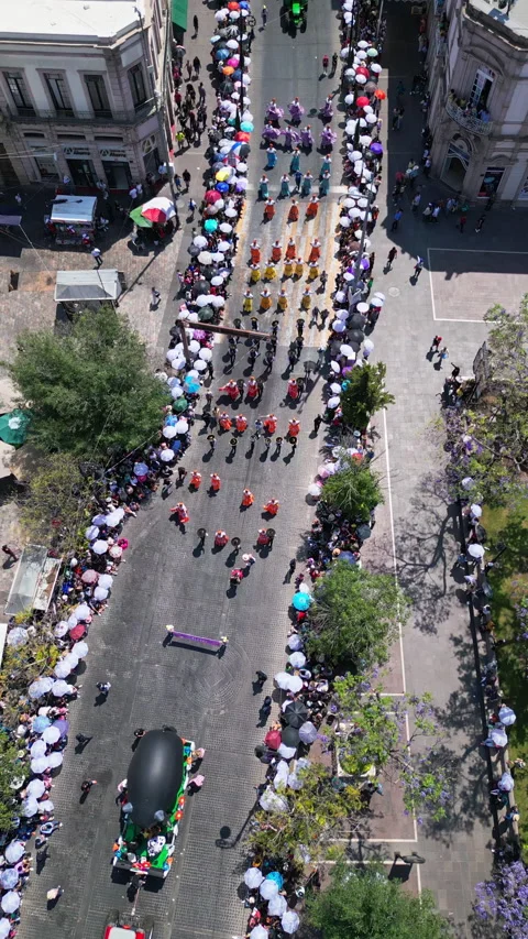 Aerial drone view of a marching band and parade contingents in the historic Stock-Footage 342062404