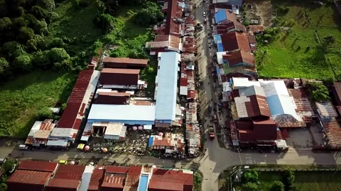 Aerial drone view of the market intersection in SP, Nabire Barat, Central Papua. Stock Footage 316200822