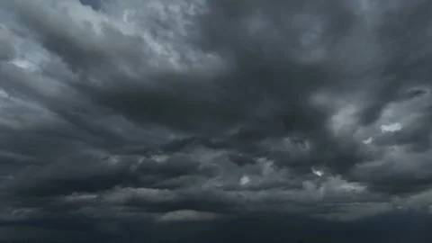 Aerial drone view of massive dark storm clouds dominating the sky. Vídeo Stock 337712108