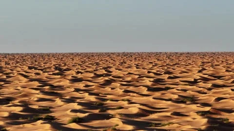 Aerial drone view of massive golden sand dunes in the Tunisian Sahara at Stock Footage 335165136