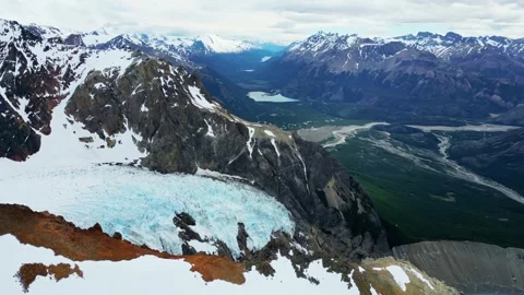 Aerial drone view of a massive mountain glacier nestled within a valley lan.. 库存影片 339373189