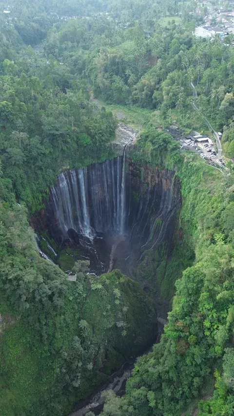Aerial Drone View of Massive Sinkhole Surrounded by Lush Tropical Forest Stock Footage 340542640