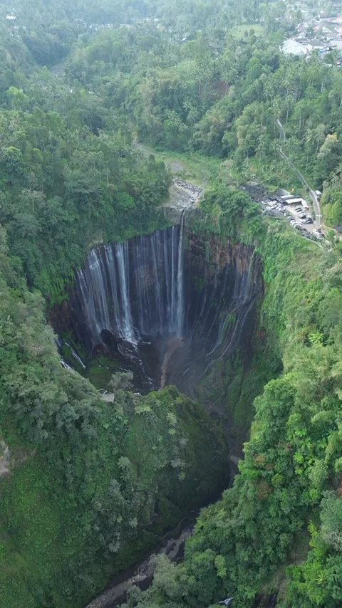 Aerial Drone View of Massive Sinkhole Surrounded by Lush Tropical Forest Stock Footage 340542654