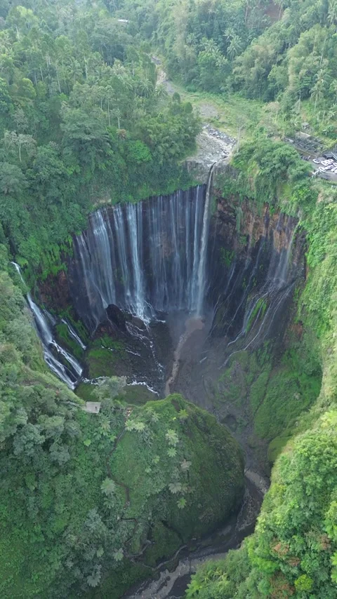 Aerial Drone View of Massive Sinkhole Surrounded by Lush Tropical Forest Stock Footage 340542681