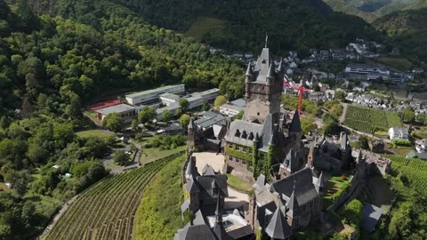 Aerial drone view of a medieval castle on a hill over a river, cinematic pan Stock Footage 336335481